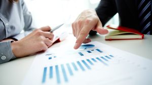 People analyzing financial graphs and charts.