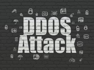 DDOS Attack text on brick wall background.