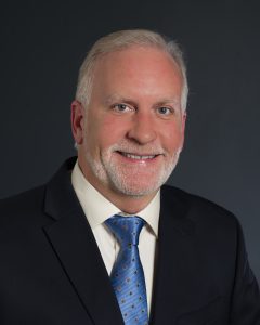 Man in suit with a blue tie.