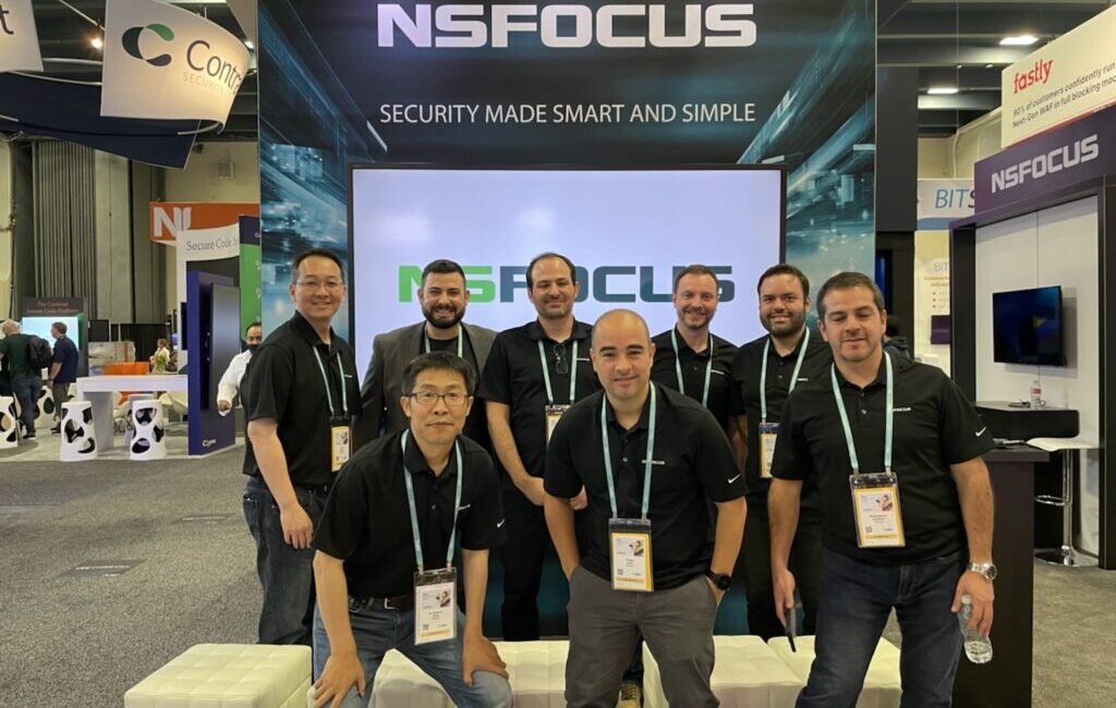Team posing at NSFOCUS exhibition booth.