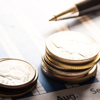 Stacks of coins on financial chart.