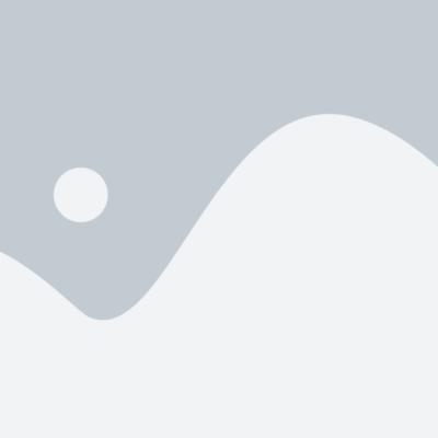 Beautiful sunrise over a calm lake with mist and silhouetted trees.