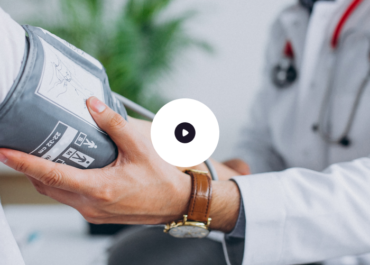 A doctor measuring a patient's blood pressure with a sphygmomanometer.