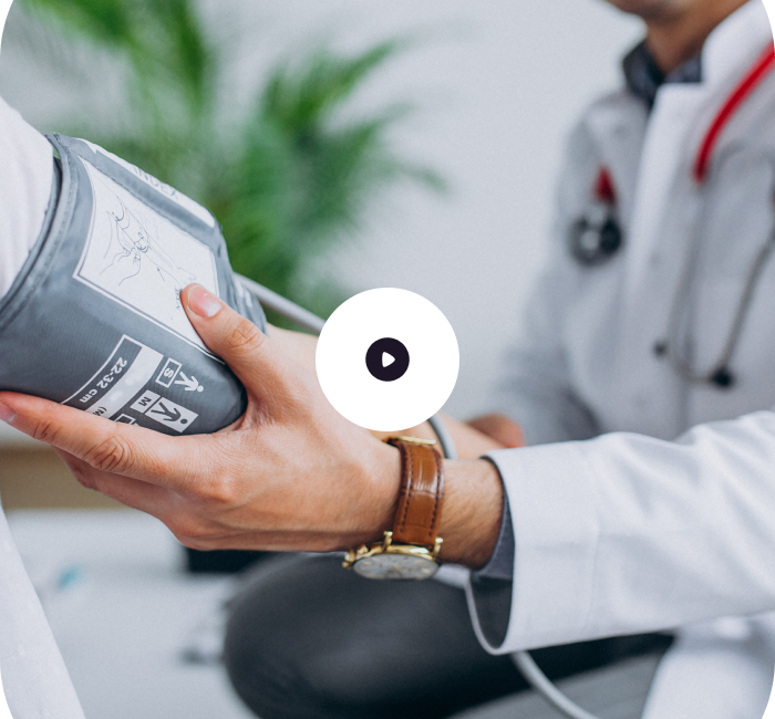 A doctor measuring a patient's blood pressure with a sphygmomanometer.