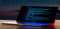 Laptop screen displays code against a dark, digital backdrop.