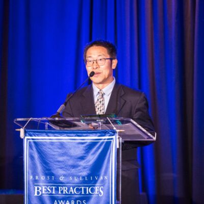 A man speaks at a podium during a formal event.
